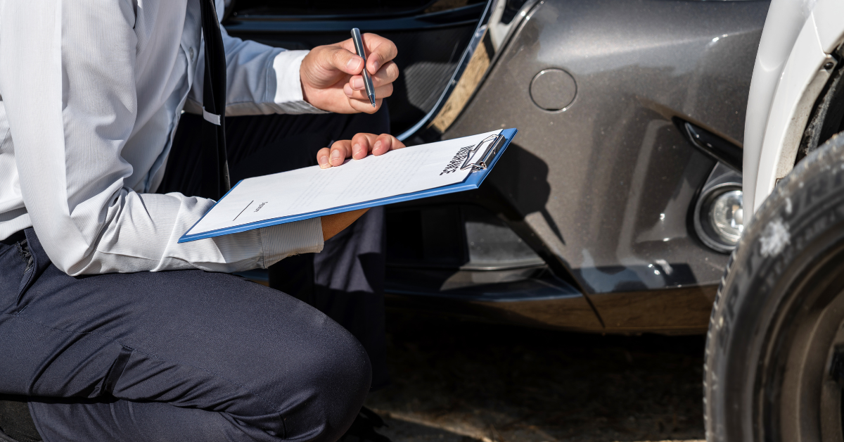 collision investigator taking notes at a car accident