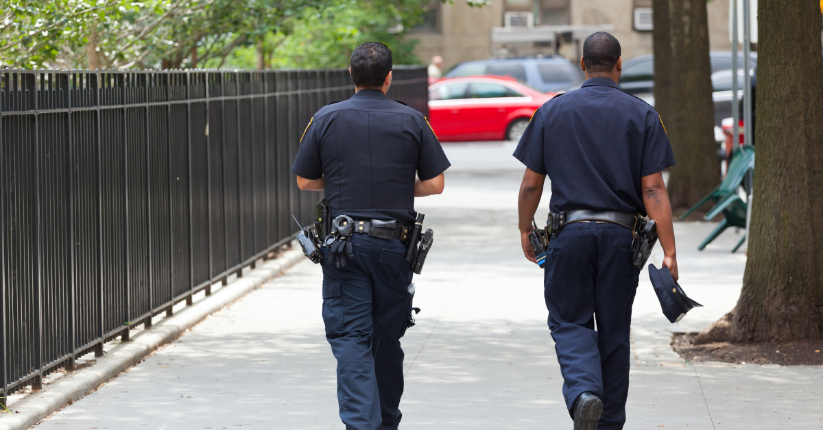 Two NYPD officers walking down the street